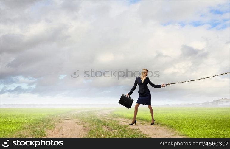 She is big fish in business. Young businesswoman walking with big exotic fish on lead