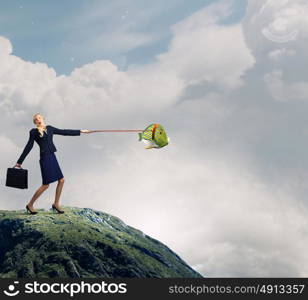 She is big fish in business. Young businesswoman walking with big exotic fish on lead