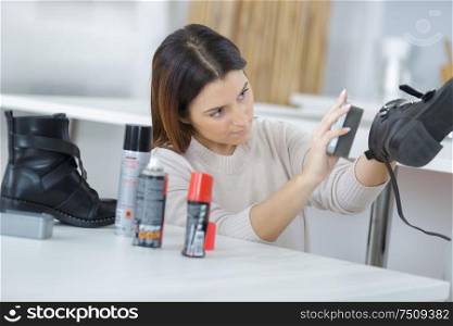 she is cleaning shoes with brush