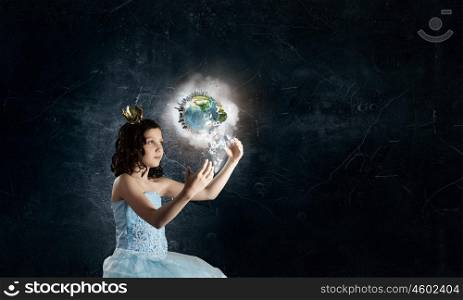 She is cute princess. Little girl princess in blue dress with diadem on head. Elements of this image are furnished by NASA