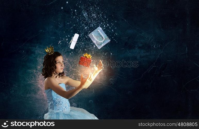 She is cute princess. Little girl princess in blue dress with diadem on head
