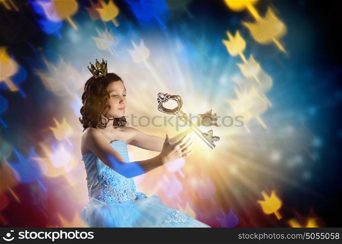 She is cute princess. Little girl princess in blue dress with diadem on head