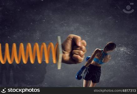 She is determined to fight. Young boxer woman attacked with glove on spring