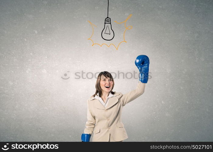 She is fighter. Young businesswoman in blue boxing gloves competition ready