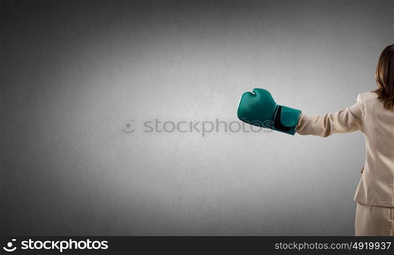 She is fighter. Young businesswoman in green boxing gloves competition ready