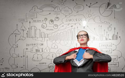 She is generator of super ideas. Businesswoman wearing red cape and opening her shirt like superhero