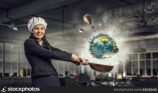 She is going to cook her idea. Pretty businesswoman in suit and cook hat with pan in hand. Elements of this image are furnished by NASA