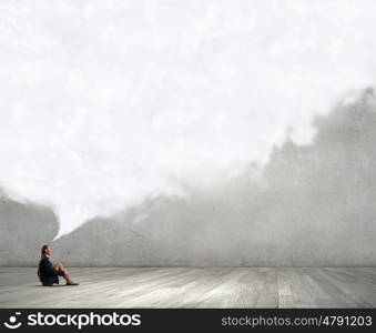 She is in dispair and isolation. Bored young businesswoman sitting alone on floor