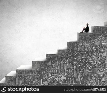 She is in dispair and isolation. Bored young businesswoman sitting alone on ladder steps