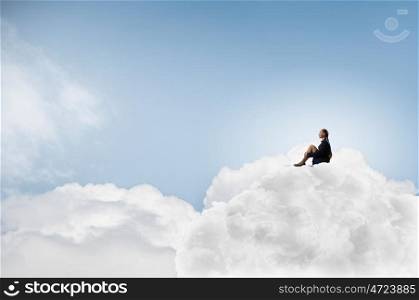 She is in dispair and isolation. Thoughtful young businesswoman sitting alone on cloud high in sky