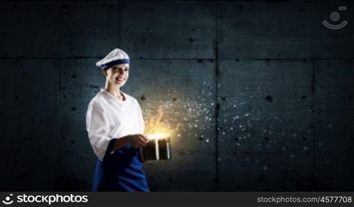 She is magician as cook. Pretty woman cook in hat and apron with pot in hands