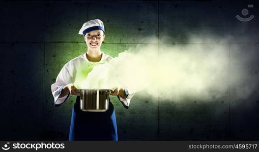 She is magician as cook. Pretty woman cook in hat and apron with pot in hands