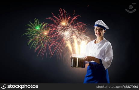 She is magician as cook. Pretty woman cook in hat and apron with pot in hands