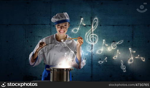 She is magician as cook. Pretty woman cook in hat and apron opening pot