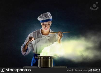 She is magician as cook. Pretty woman cook in hat and apron opening pot