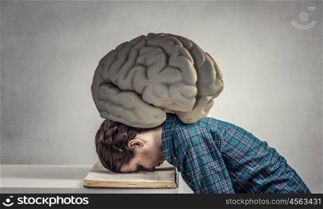 She is preparing for exams. Student girl pressed with brain to opened book pages