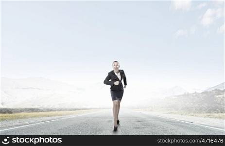She is ready to compete. Young determined businesswoman competitor running on road