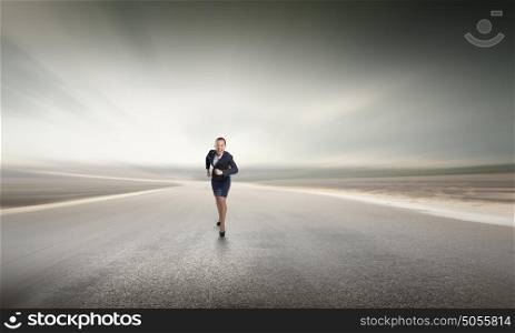 She is ready to compete. Young determined businesswoman competitor running on road