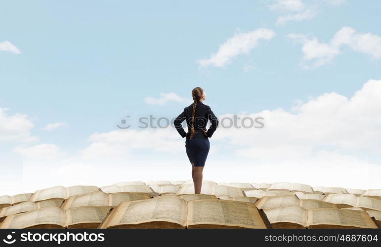 She is self assured. Back view of confident businesswoman with arms on waist