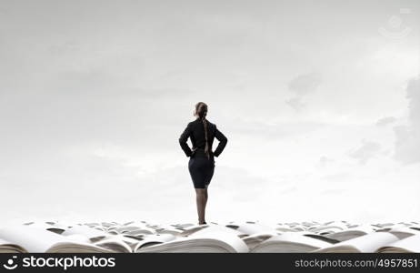 She is self assured. Back view of confident businesswoman with arms on waist