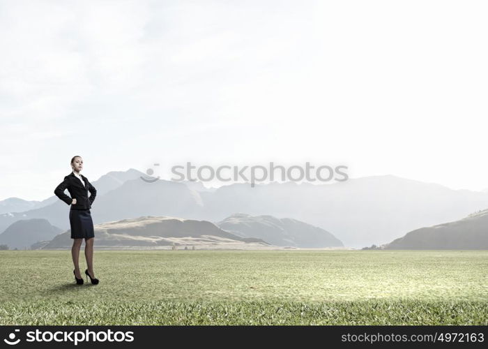 She is self confident . Young confident businesswoman with hands on waist