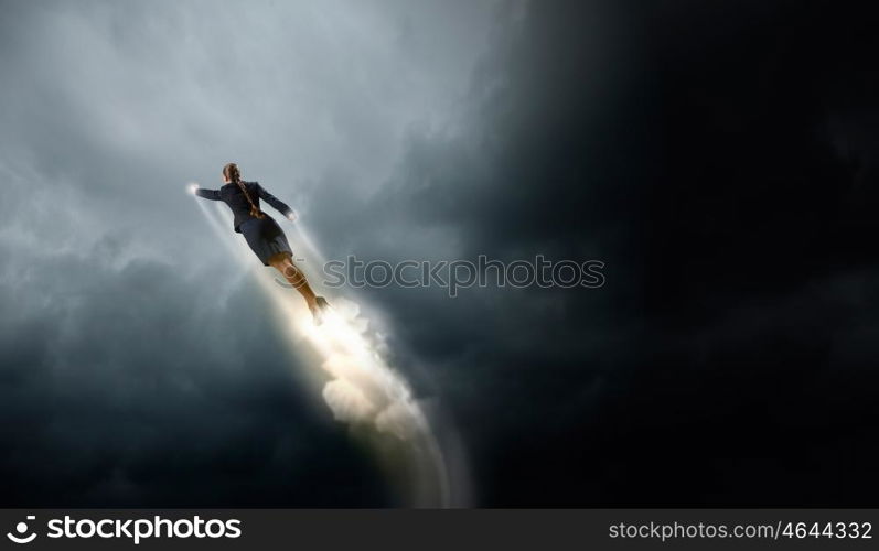 She is super woman. Businesswoman hero in suit flying up into sky