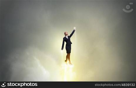 She is super woman. Businesswoman hero in suit flying up into sky