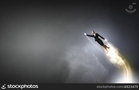 She is super woman. Businesswoman hero in suit flying up into sky