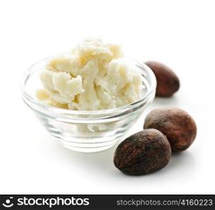 Shea nuts and sheabutter in glass bowl isolated on white