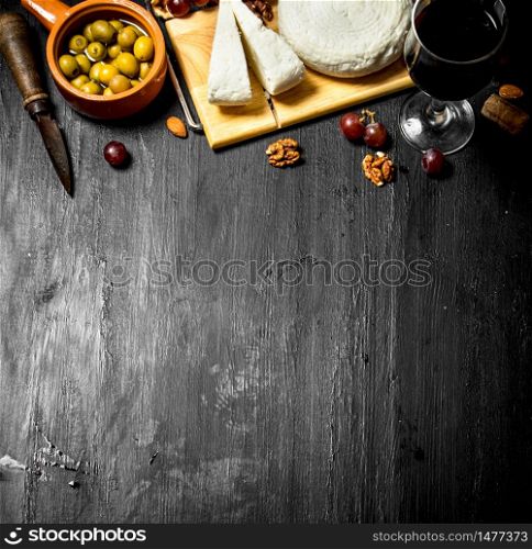 Sheep cheese with red wine , nuts and olives .. Sheep cheese with red wine , nuts and olives.