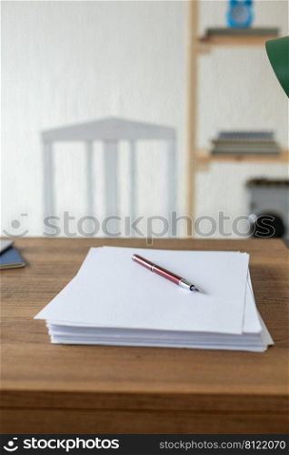 Sheet of paper on wooden desk table. Office or study creative concept