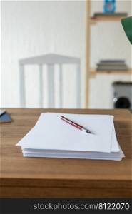 Sheet of paper on wooden desk table. Office or study creative concept