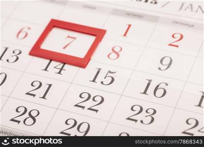 Sheet of wall calendar with red mark on framed date 7