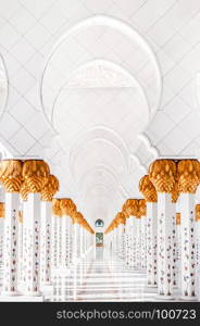 Sheikh Zayed Mosque`s hallway corridor with white arches inspired from palm tree.