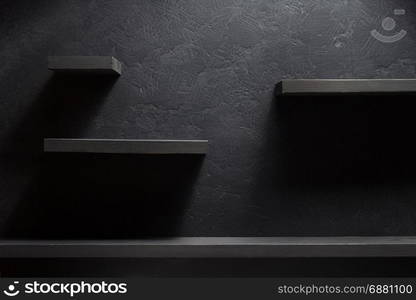 shelf and black wall wooden background