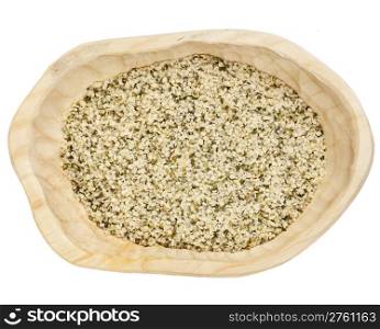shelled hemp seeds on a rustic wooden tray isolated on white - top view
