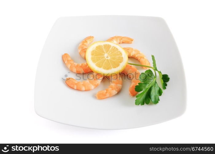 shelled shrimps with lemon and parsley on a plate isolated on white background with clipping path