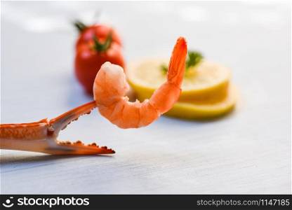 Shellfish seafood Shrimp on boiled crab claws / Shrimps prawns ocean gourmet dinner and tomato lemon on white table background