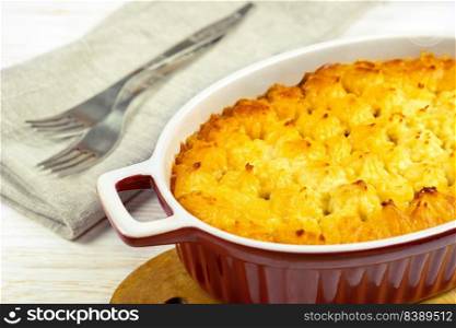 Shepherd’s pie or Cottage pie. Minced meat, mashed potatoes and vegetables casserole on white wooden background close up. Traditonal British, United Kingdom, Ireland cuisine. Shepherd’s Pie or Cottage Pie, traditional British dish on white wooden backgfound