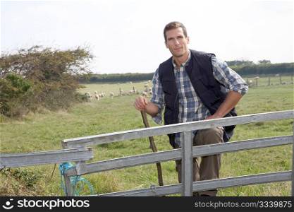 Shepherd standing in pasture land
