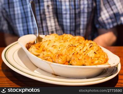Shepherds or cottage pie with baked mash potatoes in restaurant