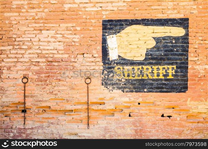 Sheriff graffiti on an old brick wall. Concept for security