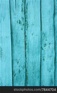 Shield of vertical wooden boards with multilayered shelled covering painted in turquoise