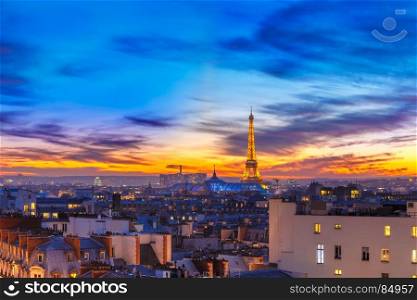 Shimmering Eiffel Tower at sunset in Paris, France. Aerial view of Eiffel tower and the rooftops of Paris during a gorgeous sunset, France