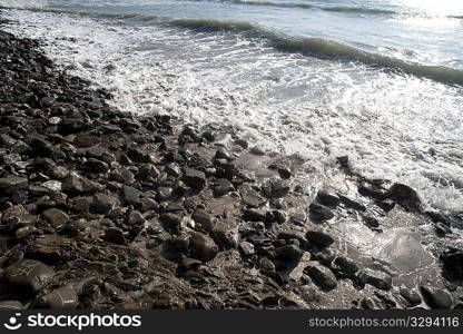 Shimmering waves on a rocky beach