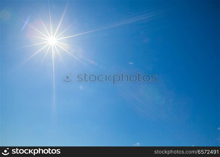 Shining sun at clear blue sky with copy space. Shining sun at clear blue sky