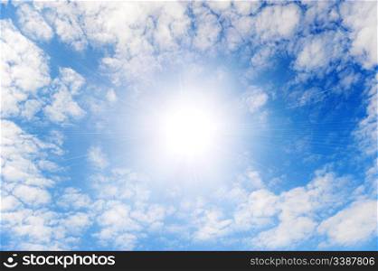 Shining sun with beams in the centre of clouds.Small wavy clouds