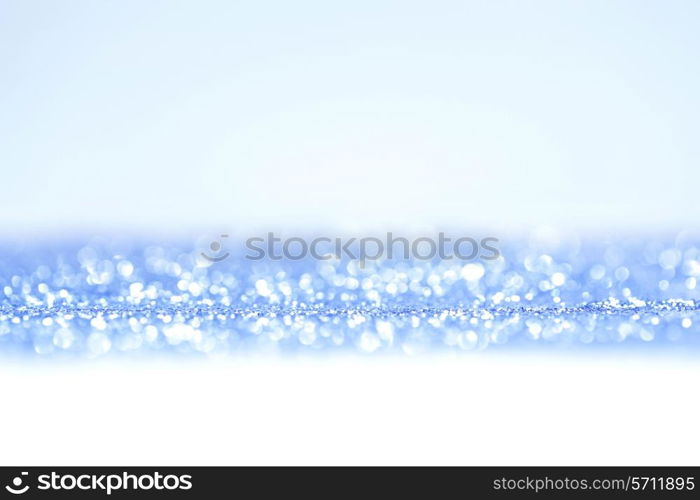 Shiny abstract blue defocused glitter background
