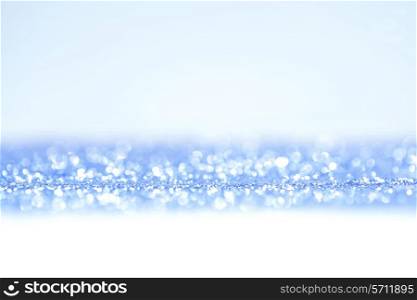 Shiny abstract blue defocused glitter background