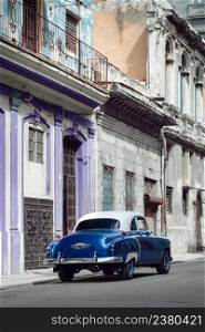 Shiny blue retro car parked on the street of Havana, Cuba